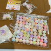 A clear plastic package filled with numerous pastel-colored squishy fidget toys shaped like cat paws.