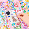 A hand applies pink glitter to a Kawaii cartoon sticker pack for DIY crafts and school supplies on a colorful background.