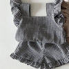 A black and white gingham ruffle top and shorts set for a baby girl summer outfit.