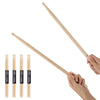 A pair of light wood maple drumsticks are shown being held, with several individual sticks laid out below.