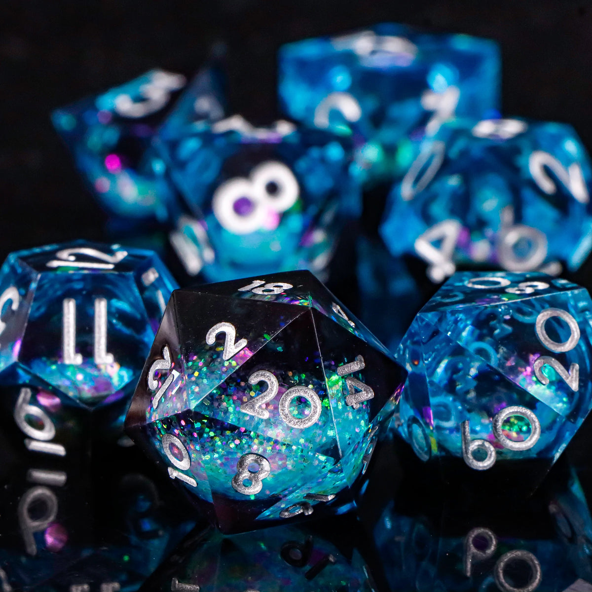 A close-up of a pile of bright blue resin dice on a dark surface.