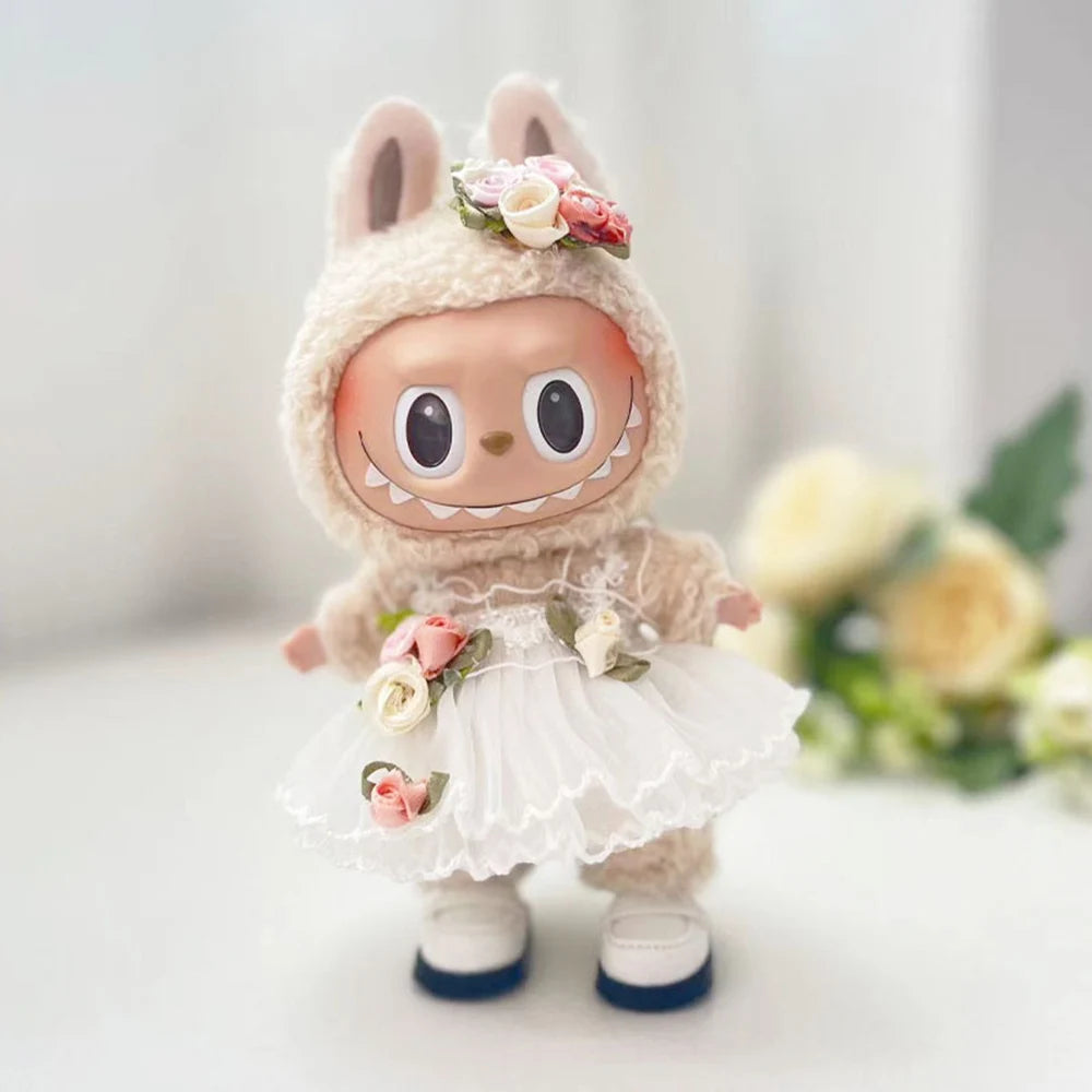 A small, fluffy rabbit doll wearing a white wedding dress outfit with floral accents.