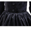 Black lace dress for a girl featuring long sleeves and a full skirt with a buttoned bodice.