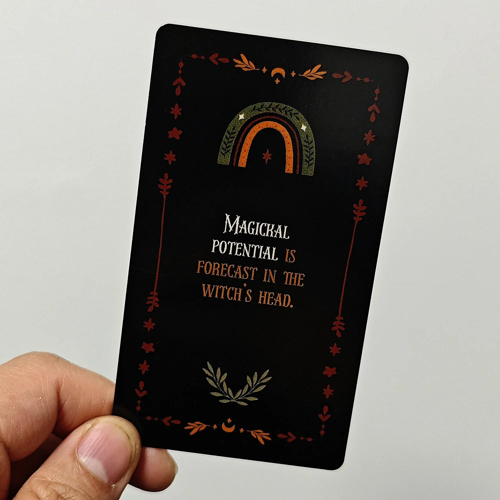 A black oracle card featuring a crescent moon and foliage, with the text Magical potential is forecast in the witch's head.
