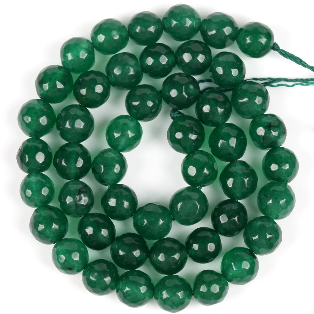 A strand of polished, deep green natural sea sediment jasper and turquoise beads for jewelry making