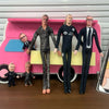 A display of five male football star stuffed dolls standing in front of a pink and yellow backdrop.