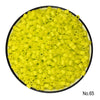 A pile of bright yellow creative fuse beads for a craft kit.