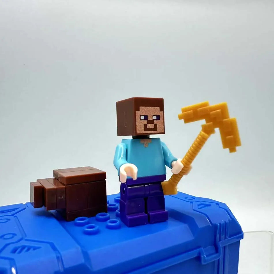 A Minecraft Steve figure with brown hair and a blue shirt holds an orange pickaxe, standing on a blue block.