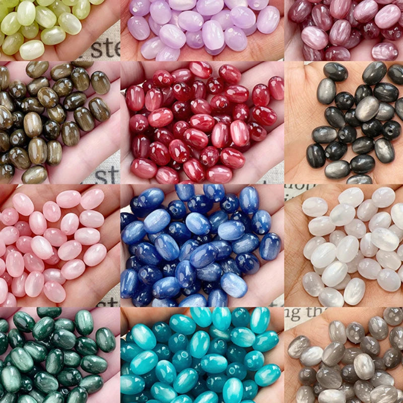 A collection of colorful resin starry sky cat's eye beads in various shades including pink, purple, red, black, and blue.