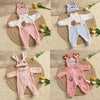A set of pink and white animal romper outfits for baby dolls, including a long-sleeved top and pants.