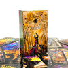 A vertical box of an illuminated Tarot card deck with a golden-yellow background and dark accents.
