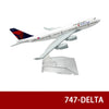 A diecast model of a Delta airplane in white and blue livery with red tail markings.