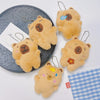 Several fluffy, light brown capybara plush keychains are displayed on a white surface.