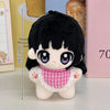 A black-haired chibi plush keychain with large purple eyes and a pink checkered collar.