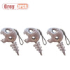 Three grey dinosaur skeleton bag charms with removable hoods