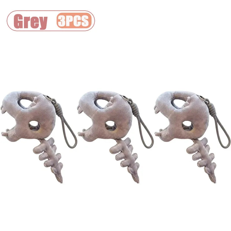 Three grey dinosaur skeleton bag charms with removable hoods