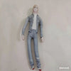A light blue plush doll dressed in a denim jacket and jeans, standing against a white background.