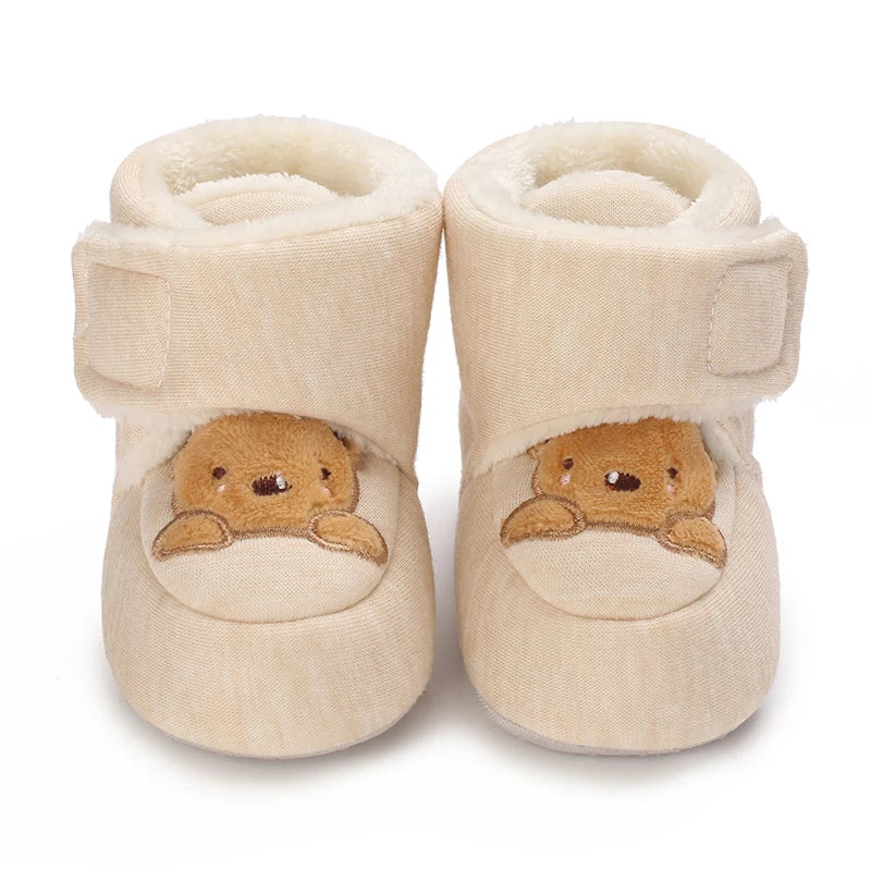 Pair of beige baby winter cartoon boots with soft lining and non-slip soles
