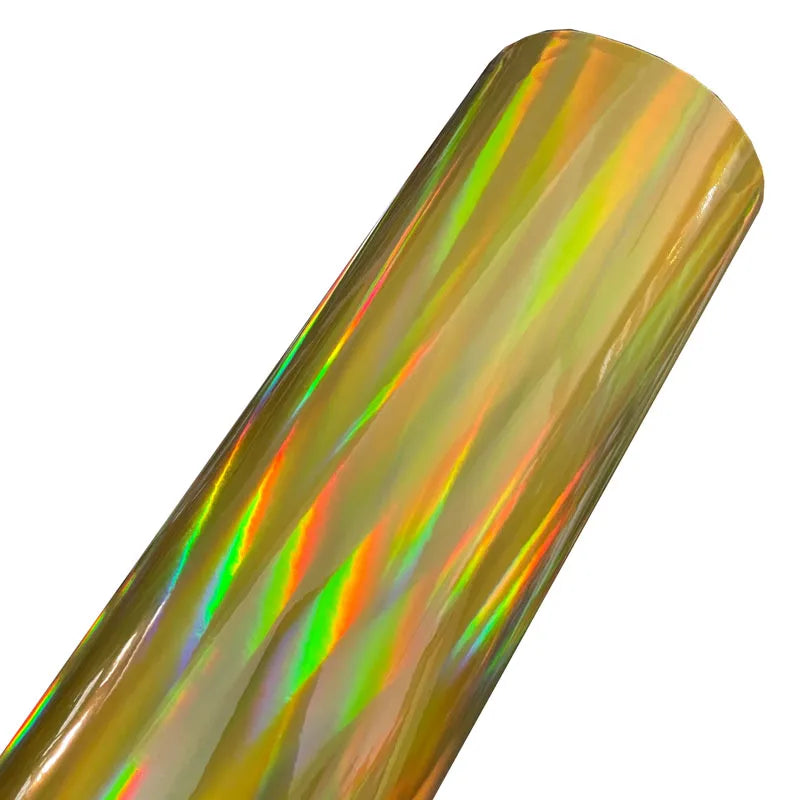 A close-up view of a roll of holographic chrome vinyl wrap featuring a rainbow iridescent finish.