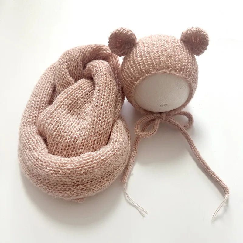 A knitted pink bear hat and wrap set for newborn photography.