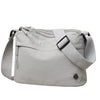 A light gray floral canvas tote bag with multiple pockets and a strap shown from the side.