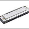 A silver harmonica with a black casing and stainless steel covers is shown in a profile view.