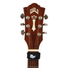 A close-up view of a guitar bridge featuring tuning pegs and a black string dampener.