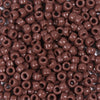 A close-up view of a 100-pack of brown, round pony beads for jewelry making and craft projects.