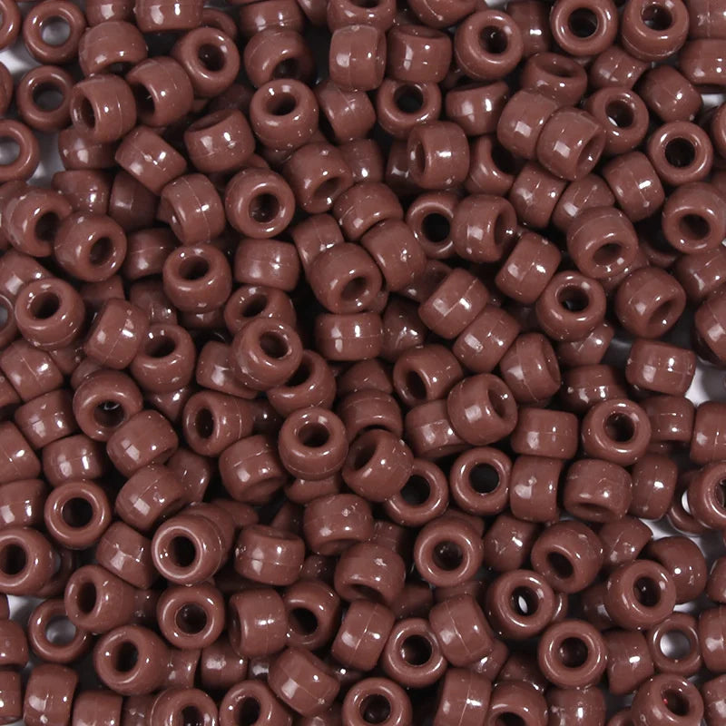 A close-up view of a 100-pack of brown, round pony beads for jewelry making and craft projects.