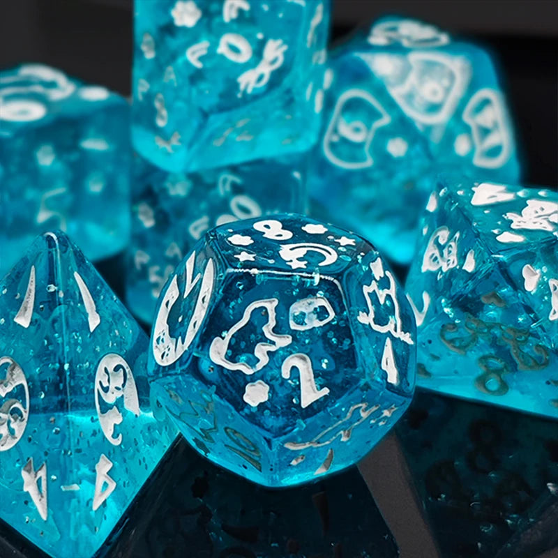A close-up of a set of blue polyhedral dice with white numbering and gold accents