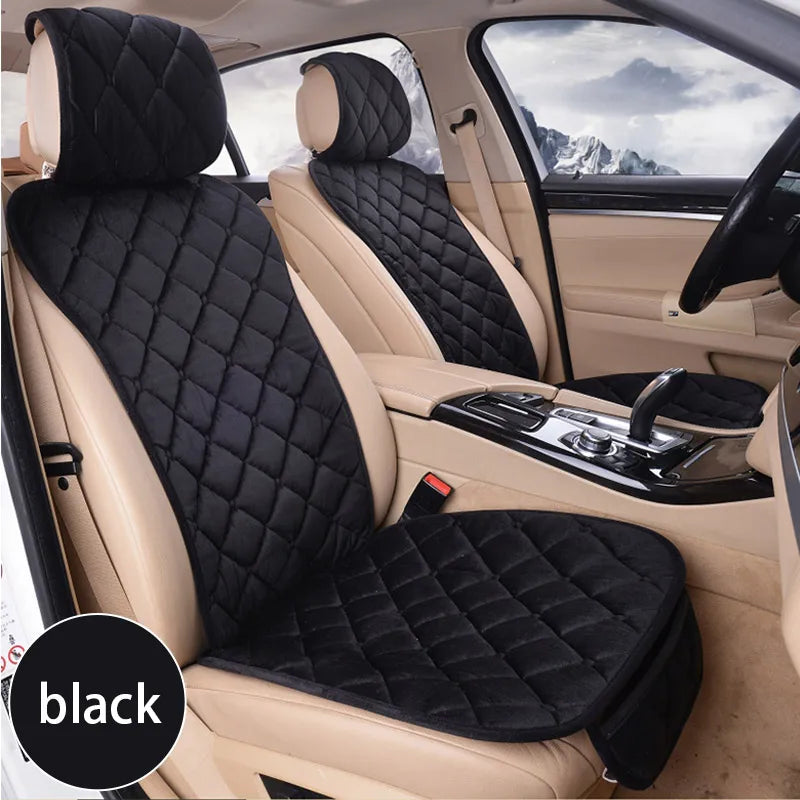 A black universal car seat protector with plush anti-slip backing installed in a light beige car seat.