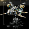 A detailed mechanical model of a dragonfly built from silver and gold parts on a black display stand.
