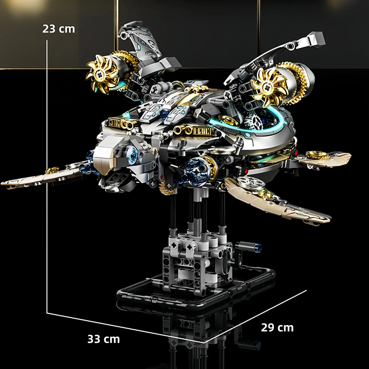 A detailed mechanical model of a dragonfly built from silver and gold parts on a black display stand.