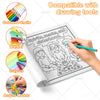 A coloring book featuring spooky scenes and characters, shown alongside various drawing tools like colored pencils, markers, 