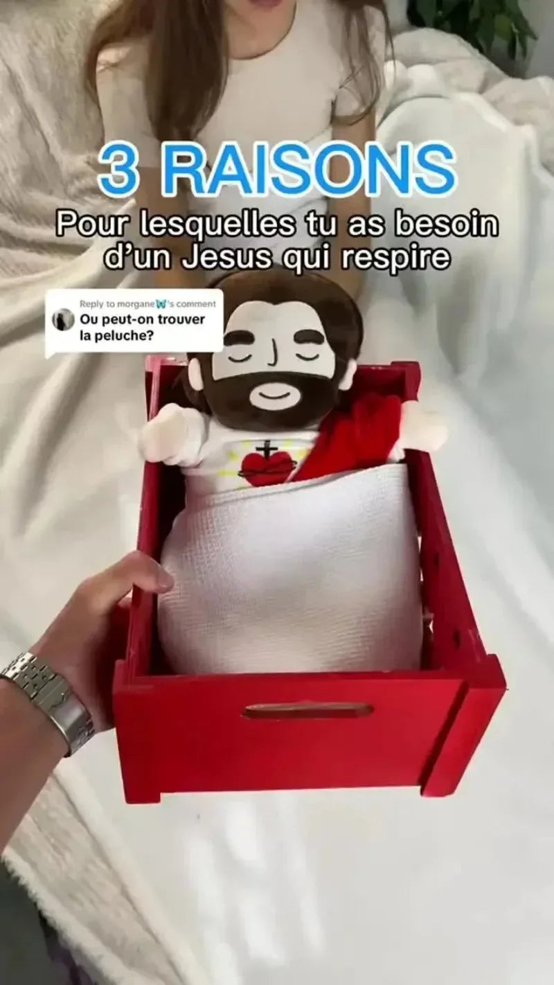 A red box containing a white plush toy of Jesus with a red cloth, set against a light background.