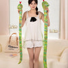 A woman holds two long, colorful cartoon snake plush toys against a window backdrop.