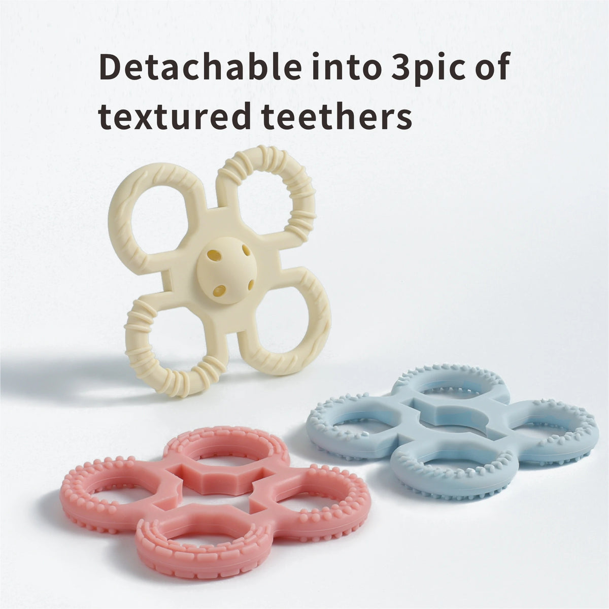 A set of three textured silicone teethers in various colors, showing them detached from a main piece.