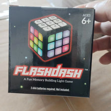A box for the Flashdash memory building light game cube with flashing lights.