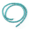 A strand of small, round, light blue turquoise beads coiled in a circle.