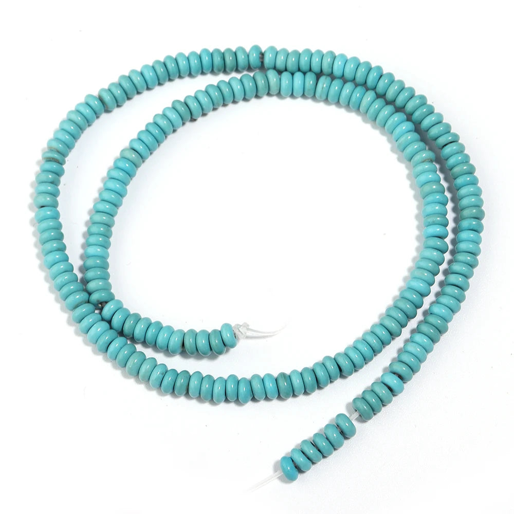 A strand of small, round, light blue turquoise beads coiled in a circle.