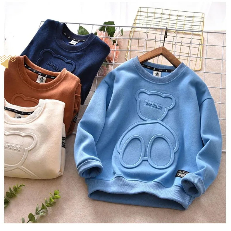 Light blue kids cartoon bear pullover sweatshirt displayed on a hanger against a neutral background.