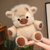 A light beige West Highland Calf plush toy resembling a running cow doll is held in a person's hand.