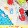Colorful locking stitch markers in various colors are shown used for knitting and crochet projects.