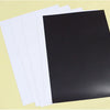 A stack of white and black flexible magnetic dry erase boards.
