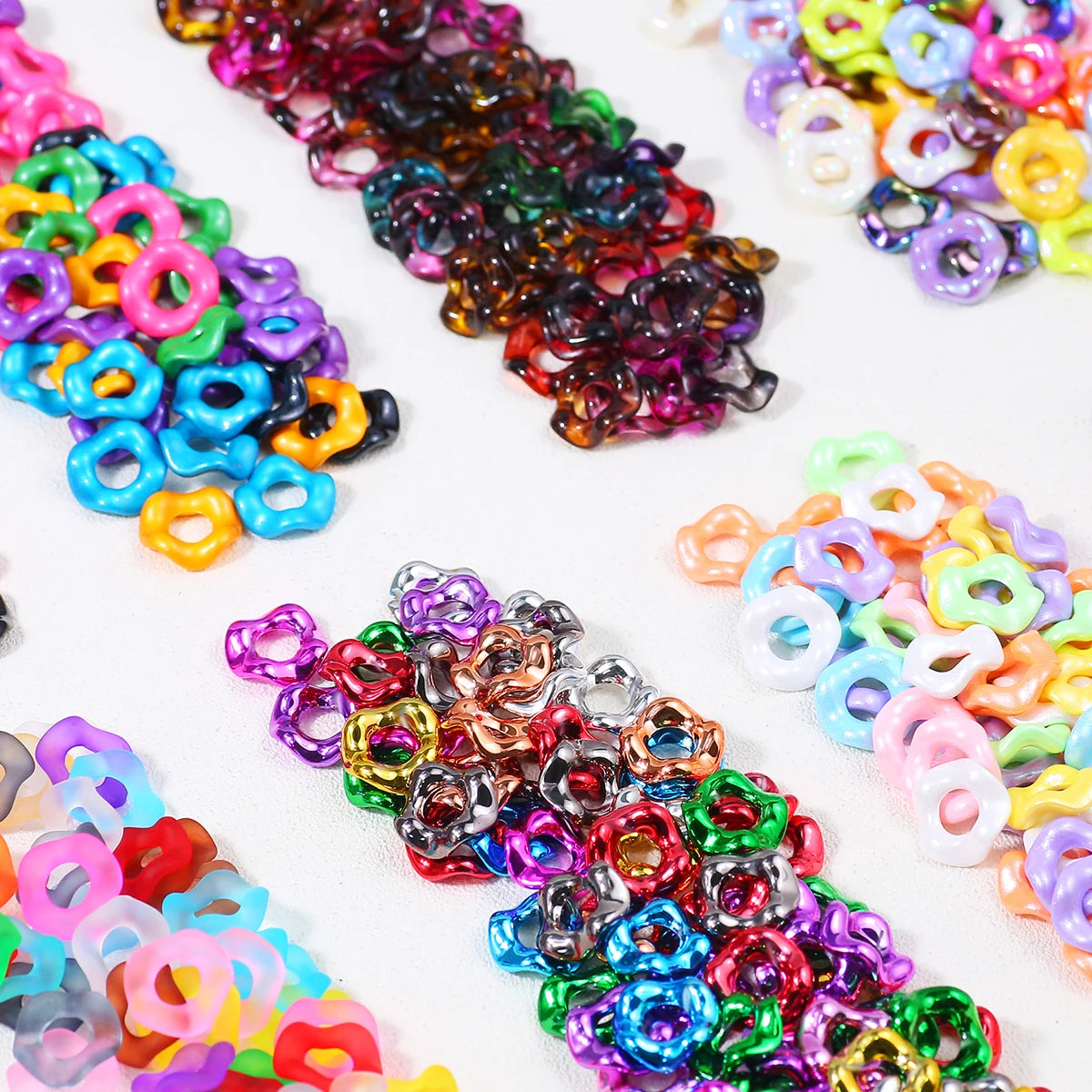 A collection of colorful, wave-patterned acrylic beads in various shades and sizes for jewelry making.
