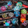 A collection of colorful and festive dice, including a dodecahedron and a tetrahedron, arranged on a dark surface.