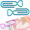 Two heart-shaped clear plastic clips used for diamond painting canvas