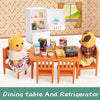 A dollhouse furniture set featuring a dining table and refrigerator with miniature kitchen items.