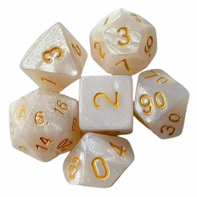 A set of seven polyhedral dice in translucent white and gold colors for tabletop gaming.