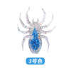 A realistic, laser-reflective flexible fishing lure shaped like a spider, featuring blue and iridescent glitter.